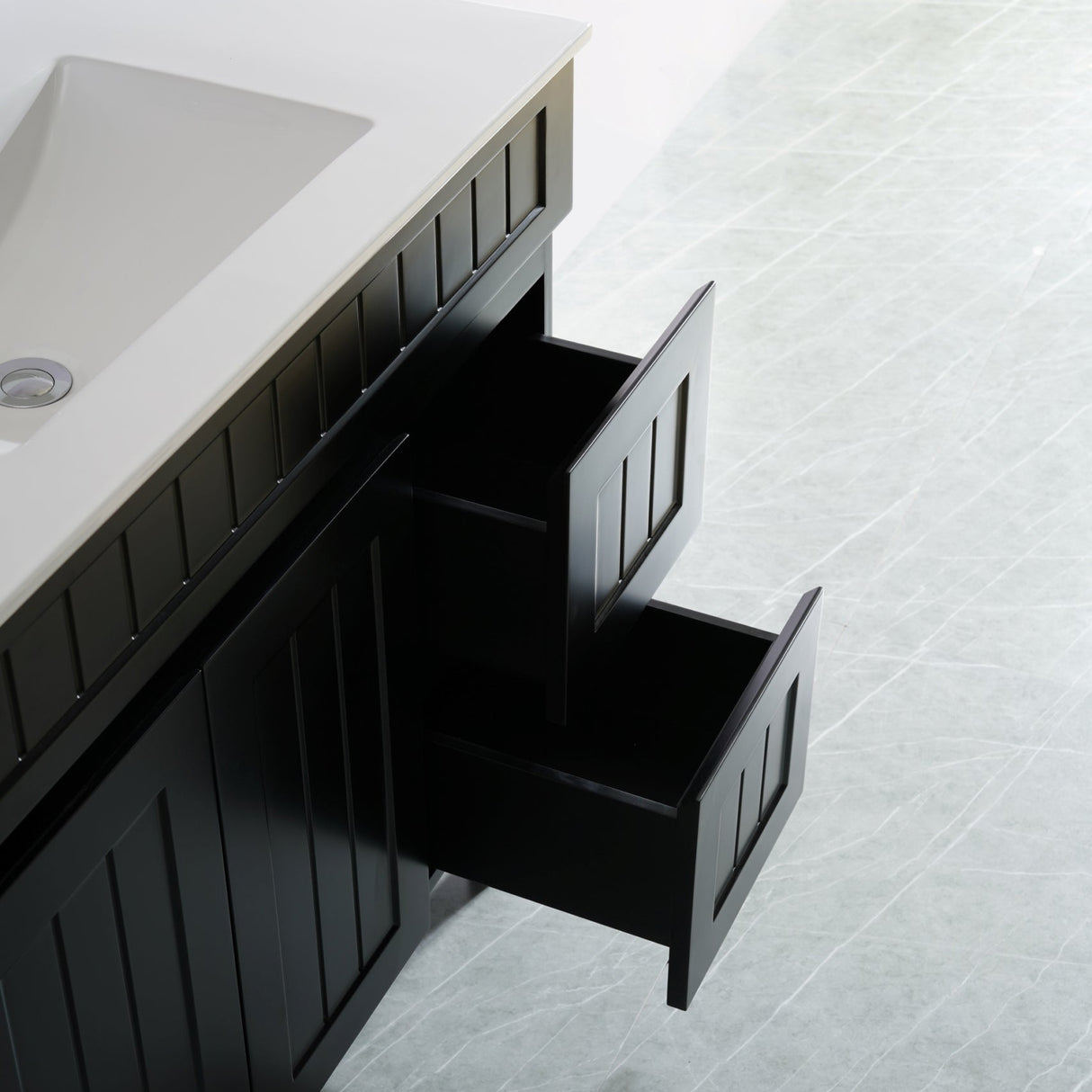 Bathroom vanity with open drawer on a tiled floor