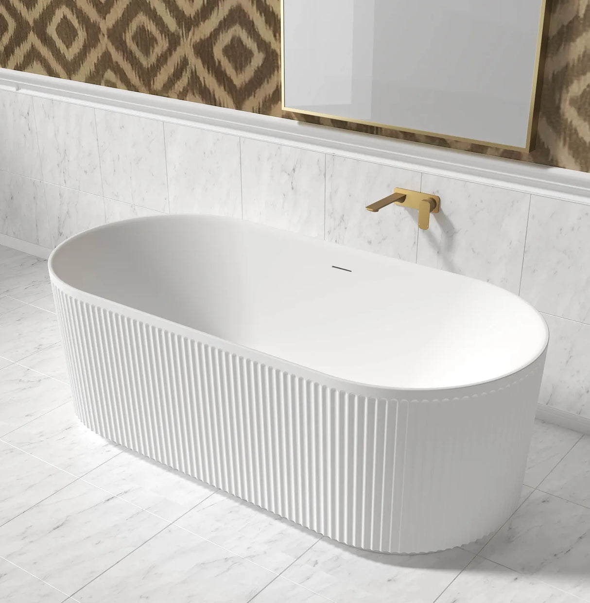 White freestanding bathtub in a bathroom with marble walls and a patterned wall hanging.