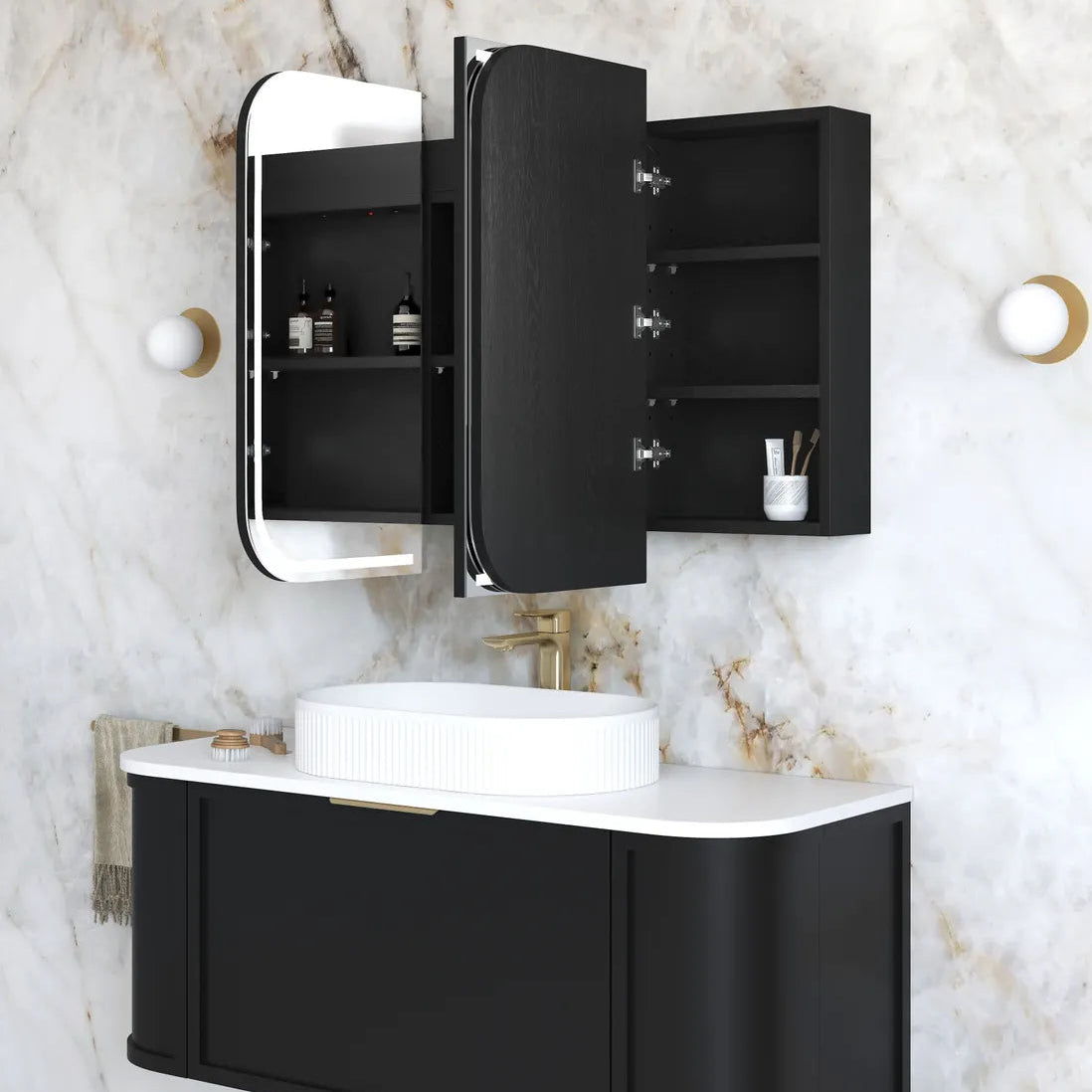 Bathroom setup with black vanity unit, mirror, and sink on a marble wall.