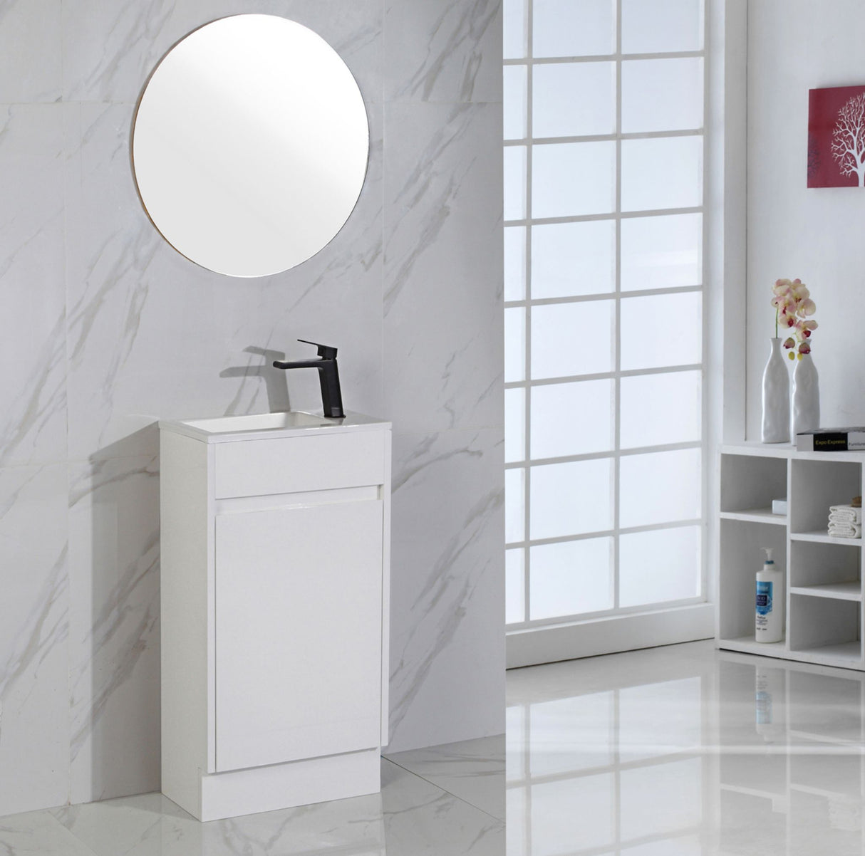 Bathroom vanity with round mirror and black faucet against a marble wall.