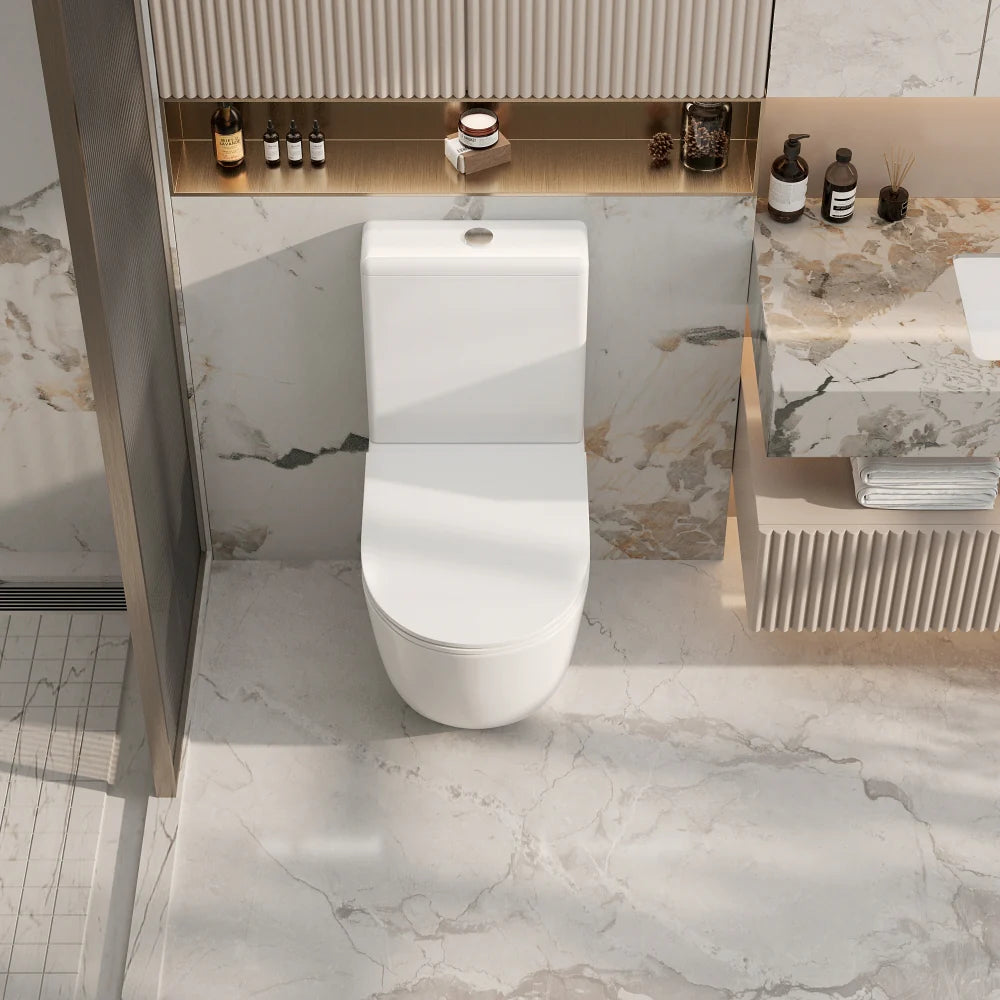 Modern white toilet in a bathroom with marble walls and floor