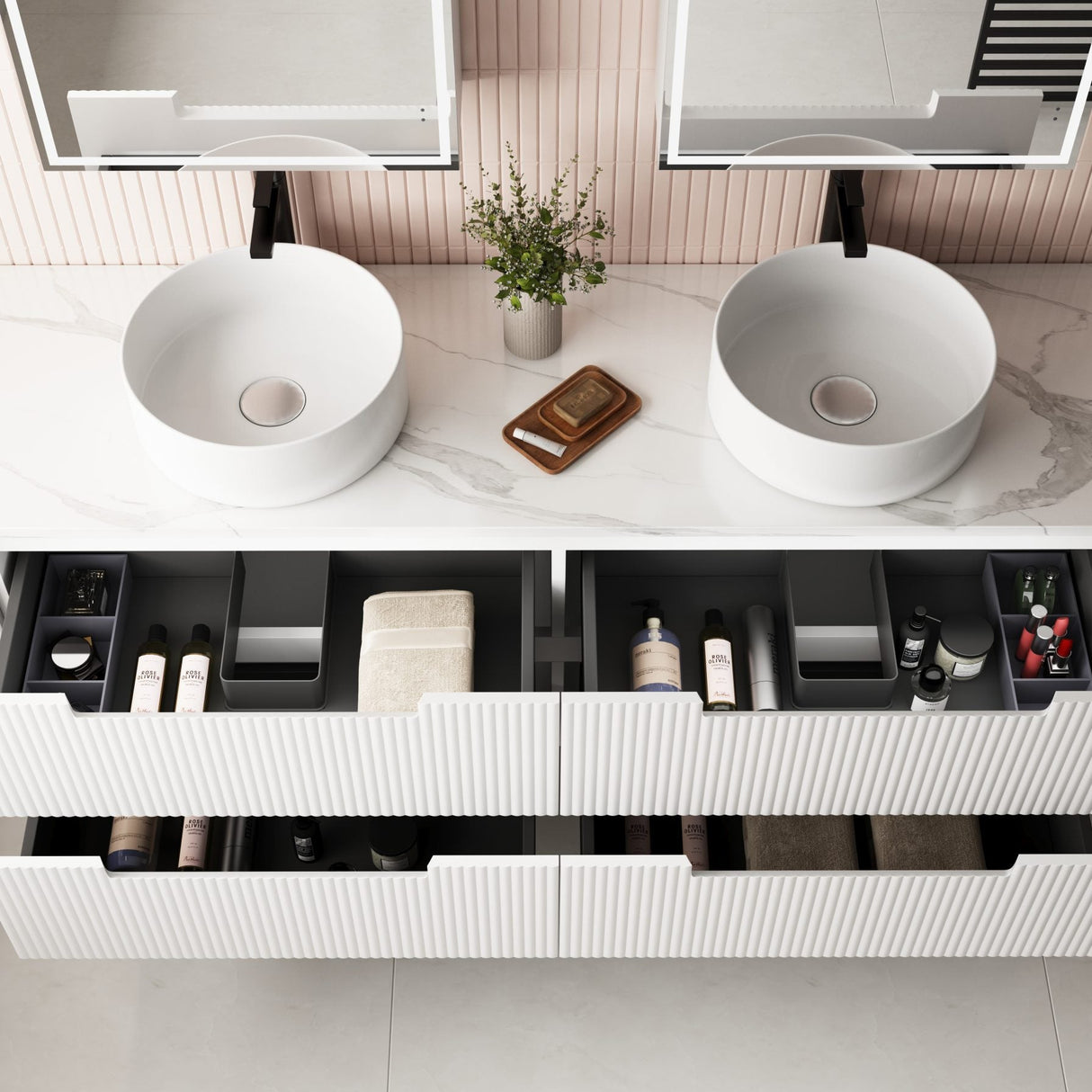 Bathroom vanity with two round sinks and open drawers.
