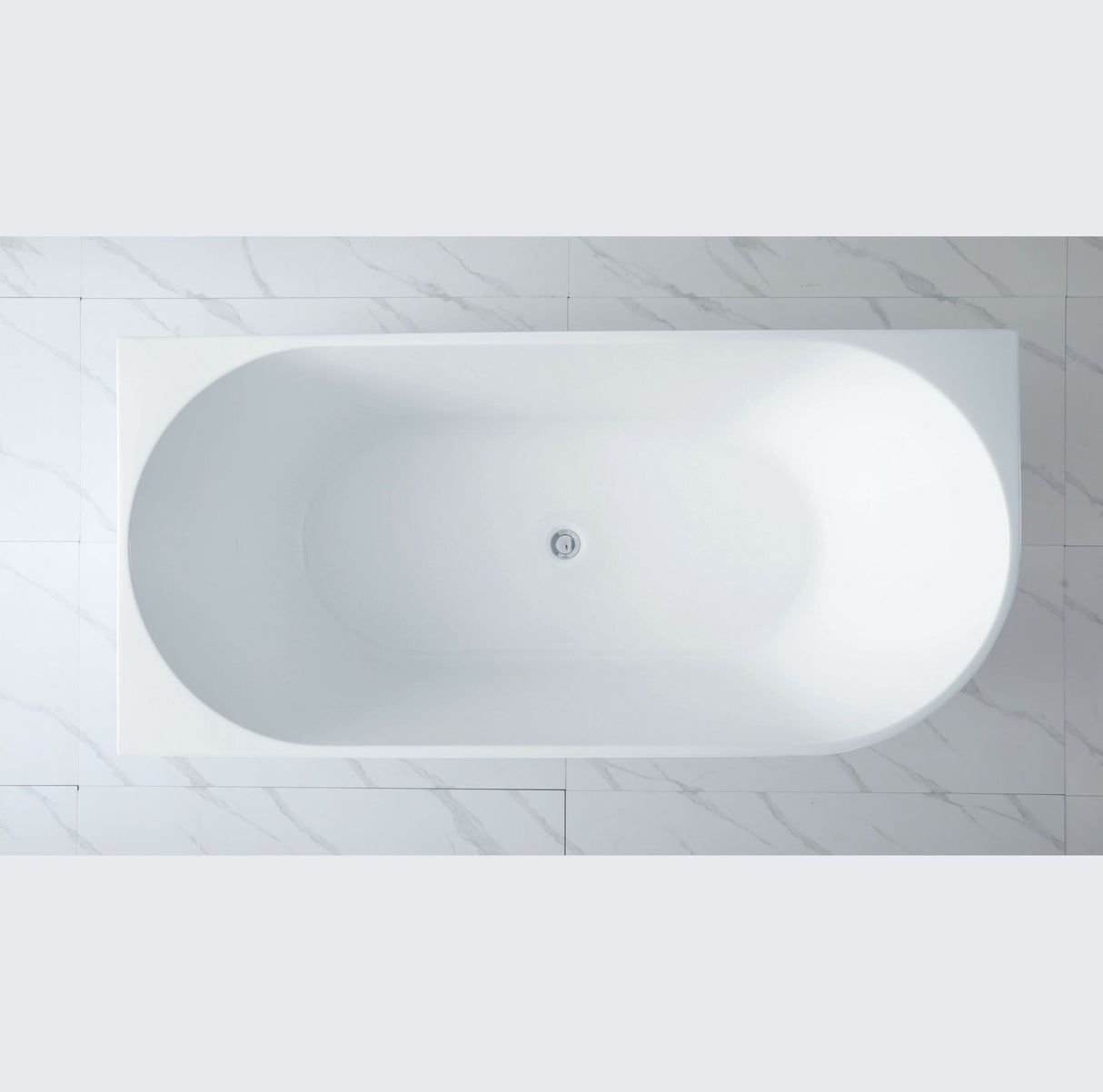 White freestanding bathtub in a bathroom with tiled walls.