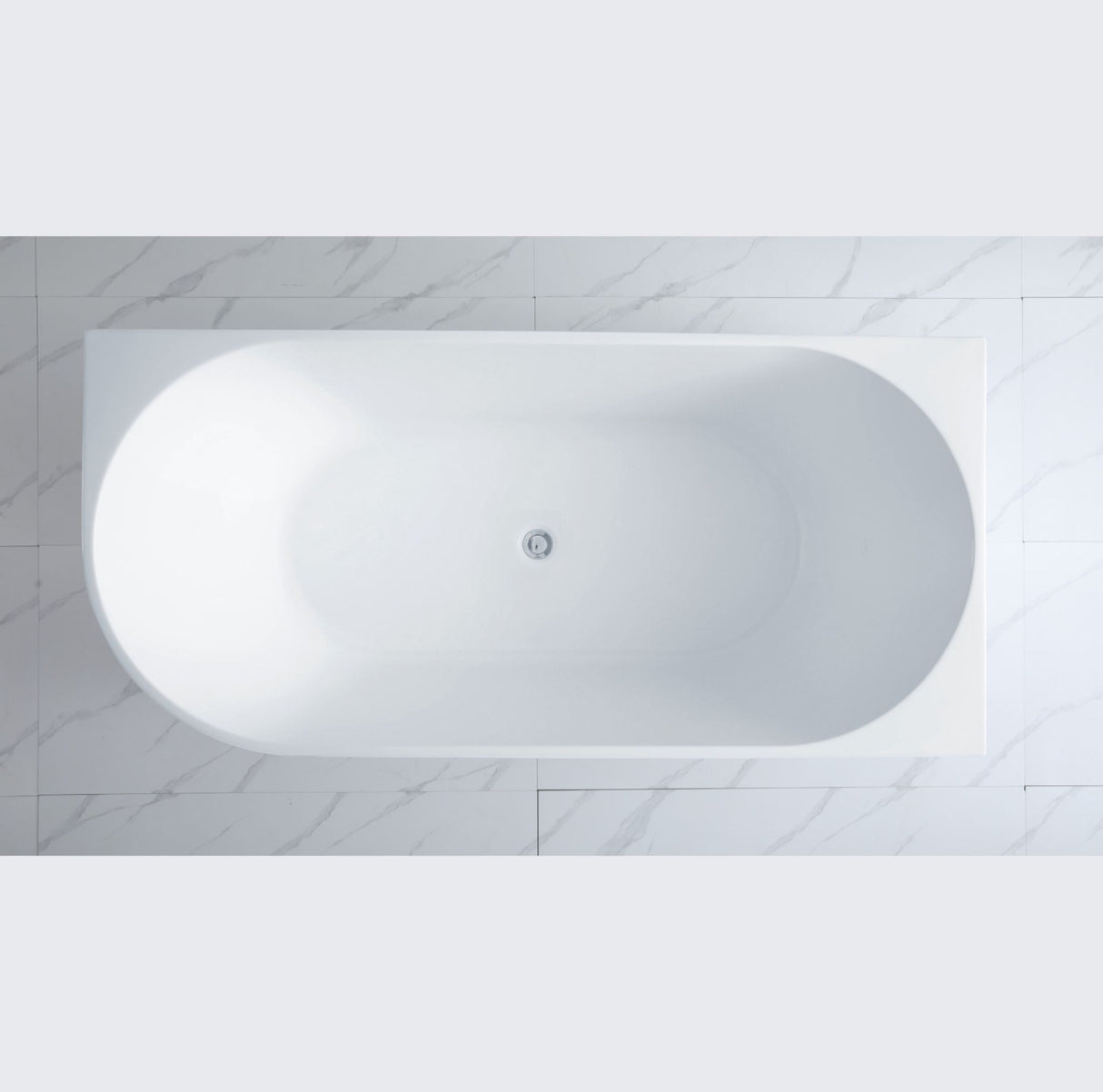 White oval bathtub against a light gray tiled wall