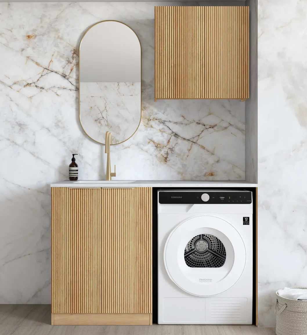 Modern laundry room with wooden cabinets, white dryer, and marble wall.