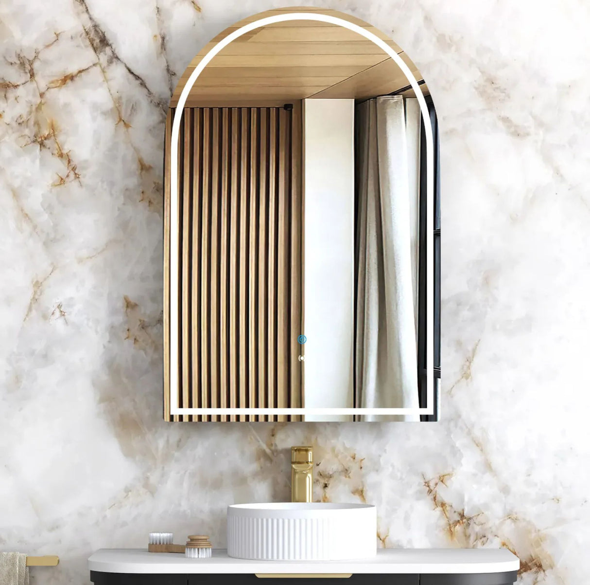 Bathroom vanity with a decorative mirror on a marble wall