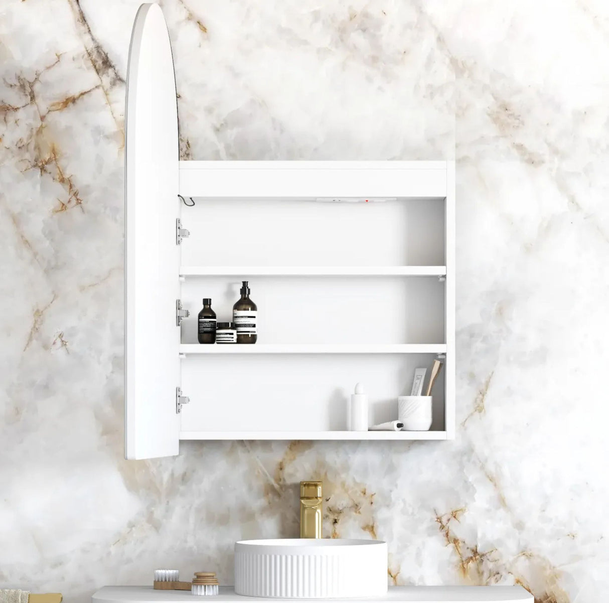 White bathroom cabinet with shelves against a marble wall.