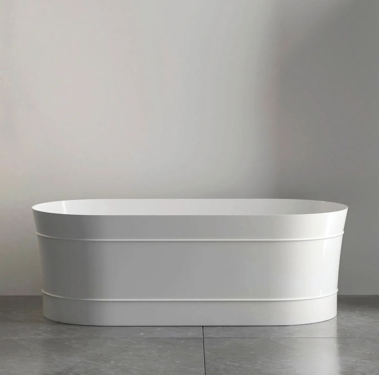 White freestanding bathtub against a gray wall