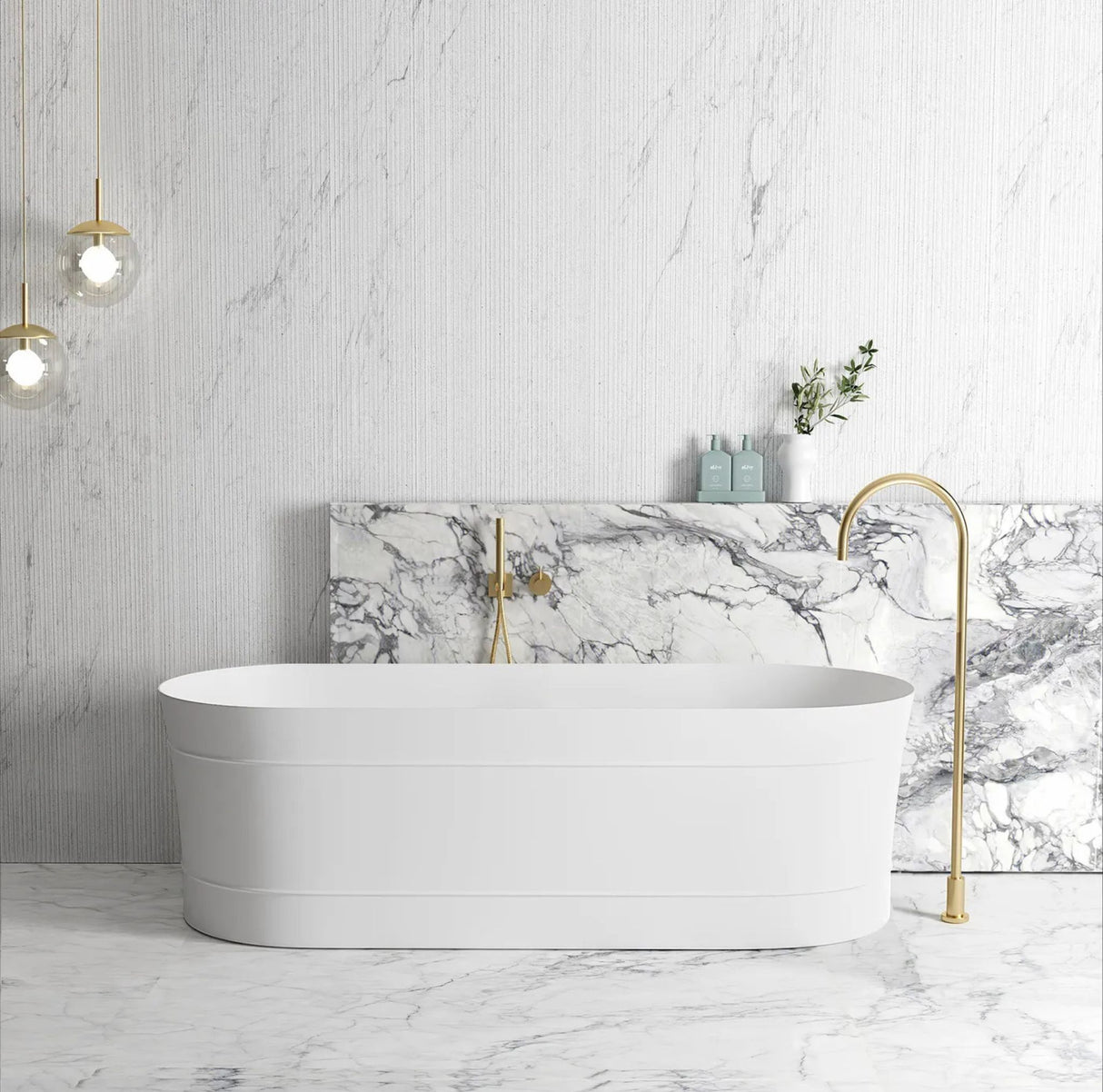 Modern bathroom with a freestanding bathtub, marble wall, and gold fixtures.