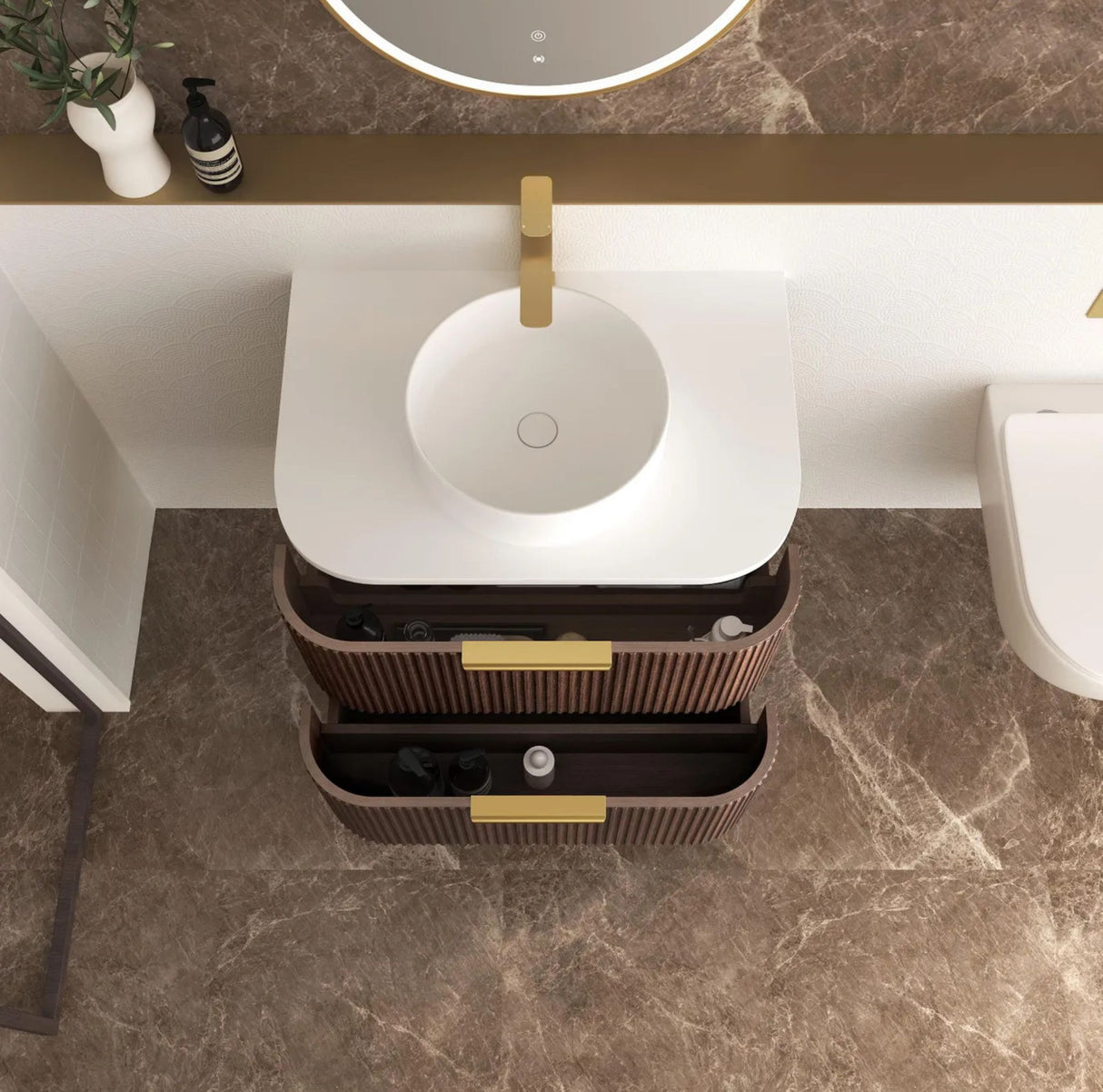 Bathroom vanity with a trash can underneath on a marble floor.