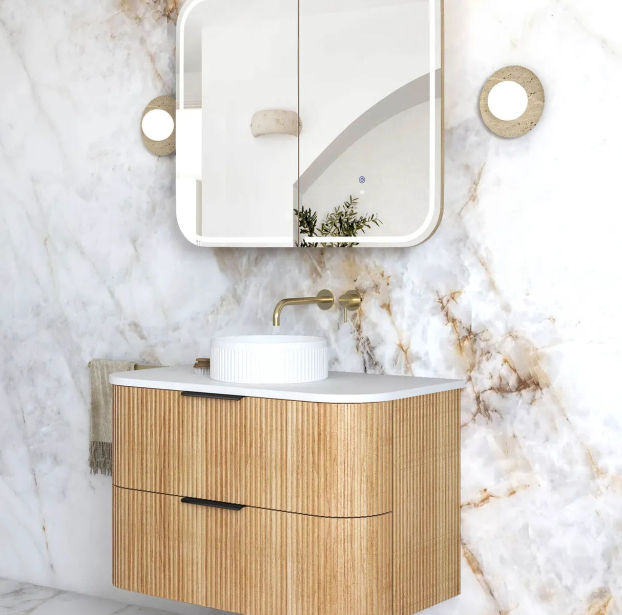 Bathroom vanity with wooden cabinet, white countertop, and mirror on marble wall.