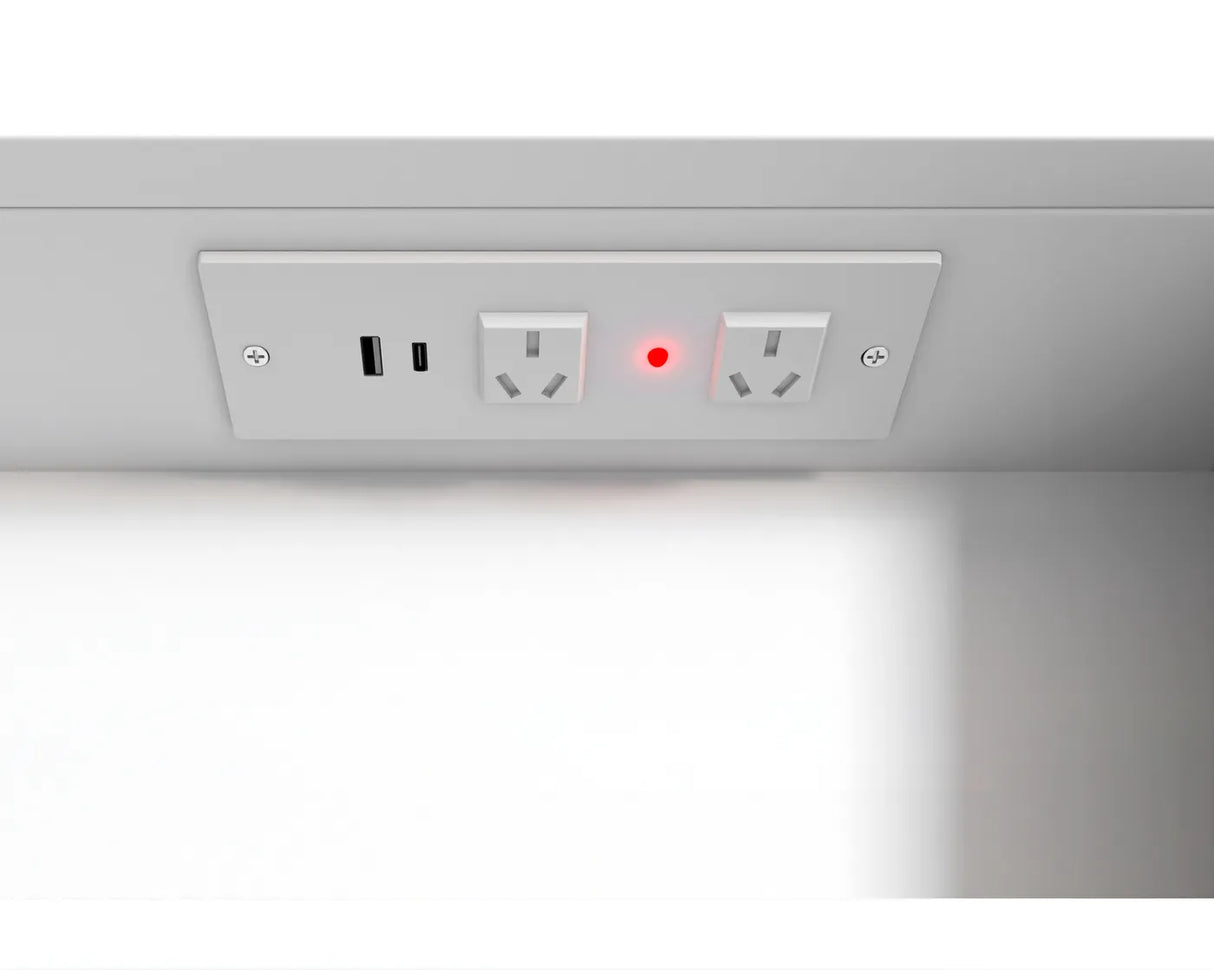 Power outlet with USB and USB-C ports under a cabinet.