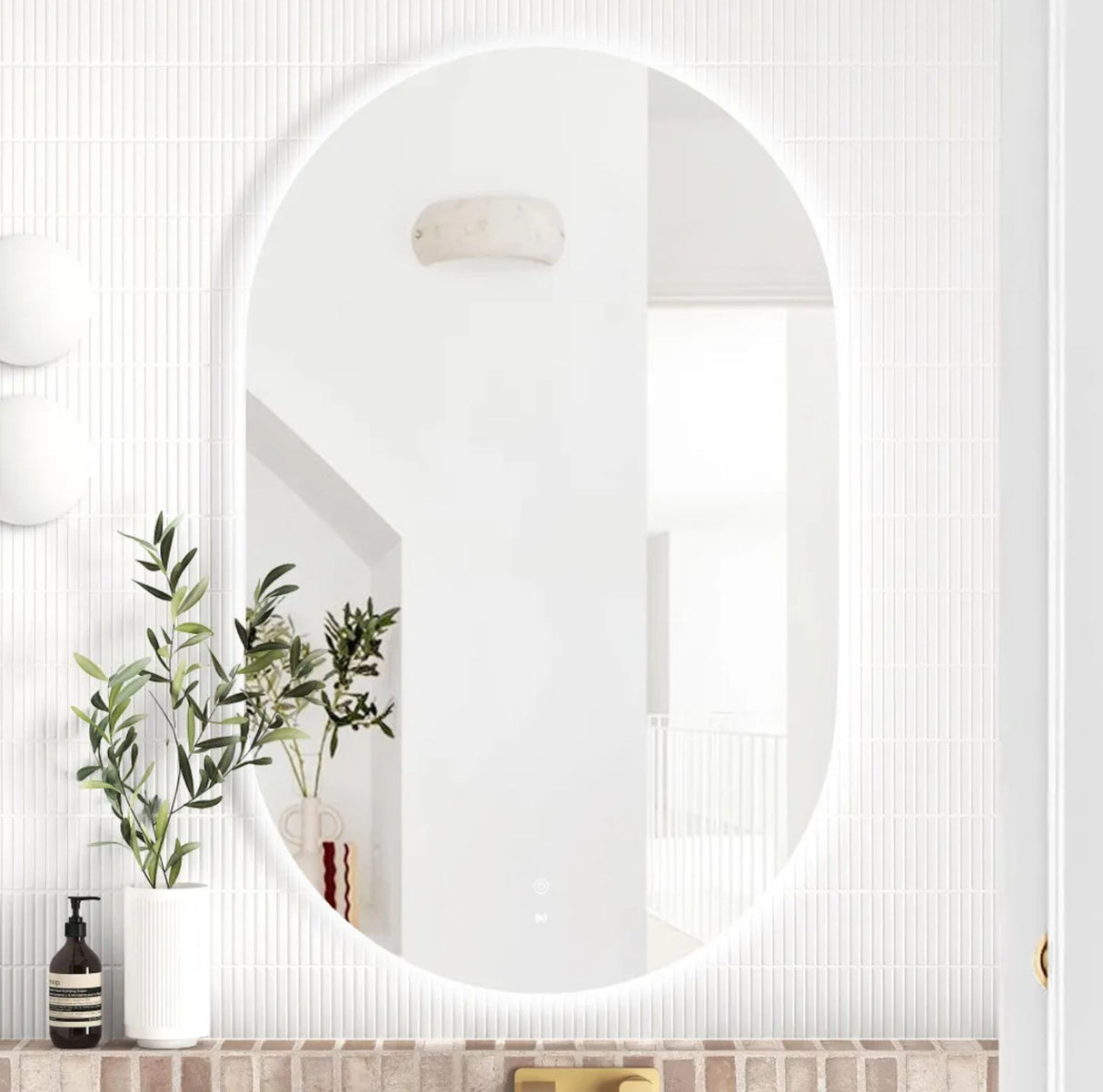 Round mirror on a white wall with decorative elements