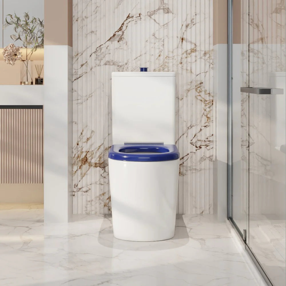 White toilet with blue seat in a modern bathroom with marble walls.