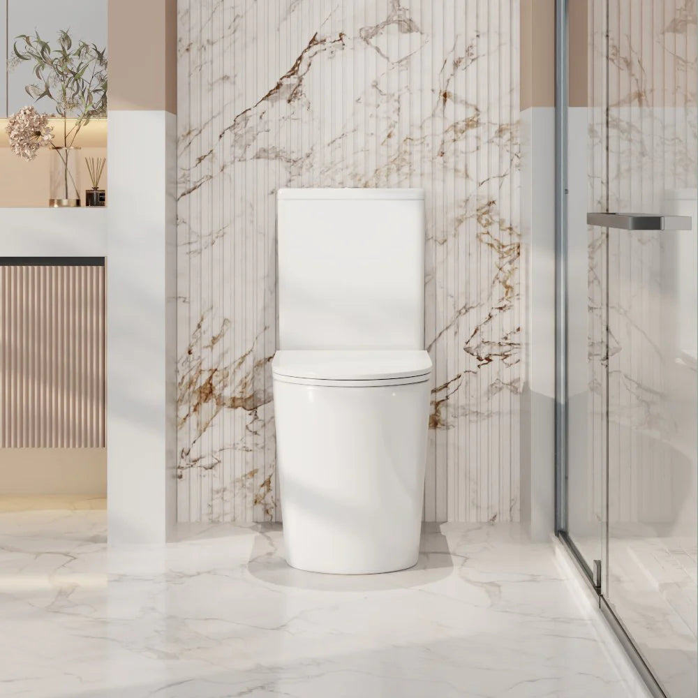 Modern toilet in a stylish bathroom with marble walls and a glass shower enclosure.