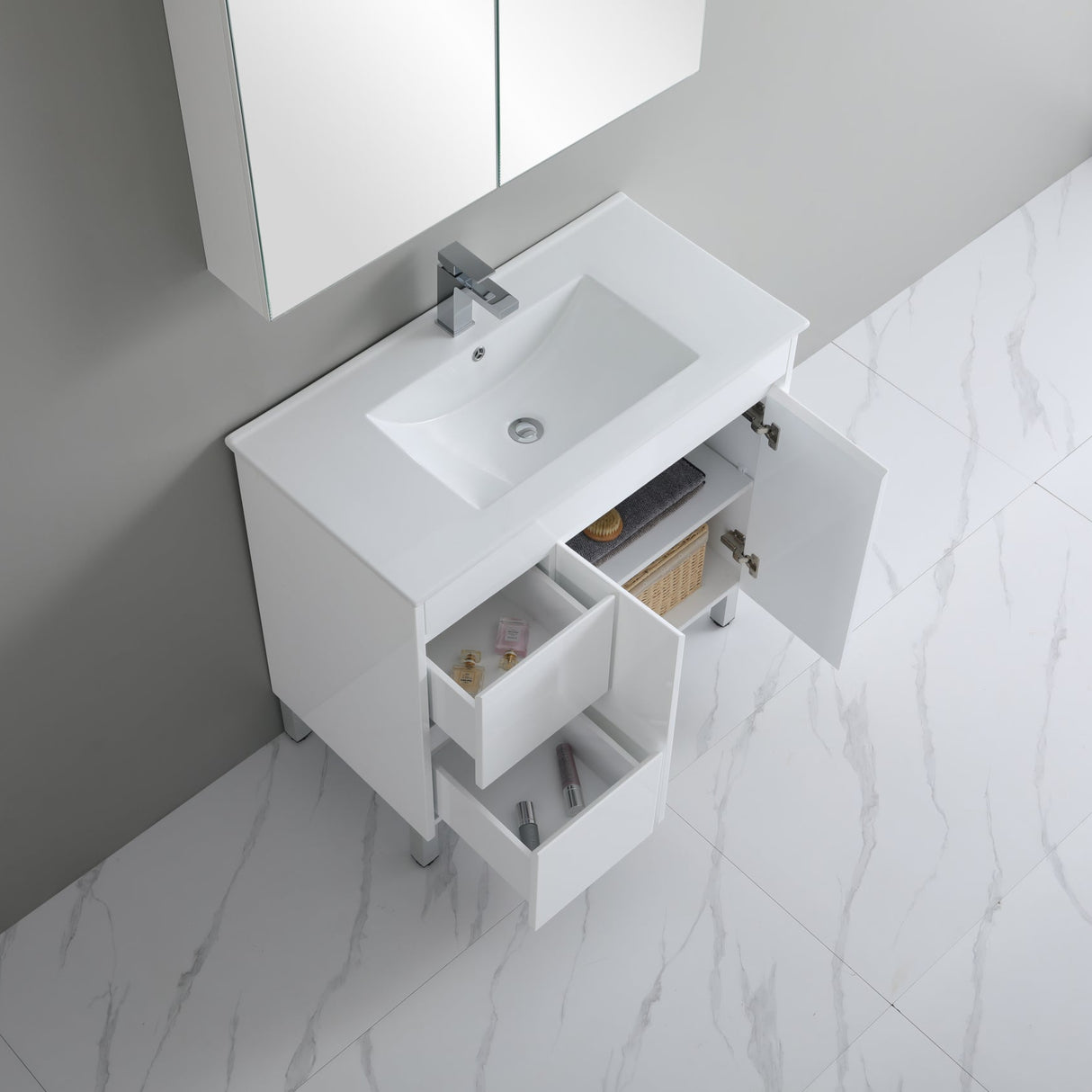 Bathroom vanity with white sink and open cabinet doors on a marble floor.