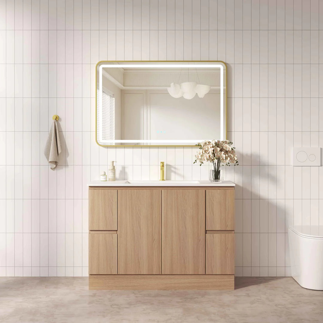 Bathroom vanity with wooden cabinet, mirror, and sink against a tiled wall.