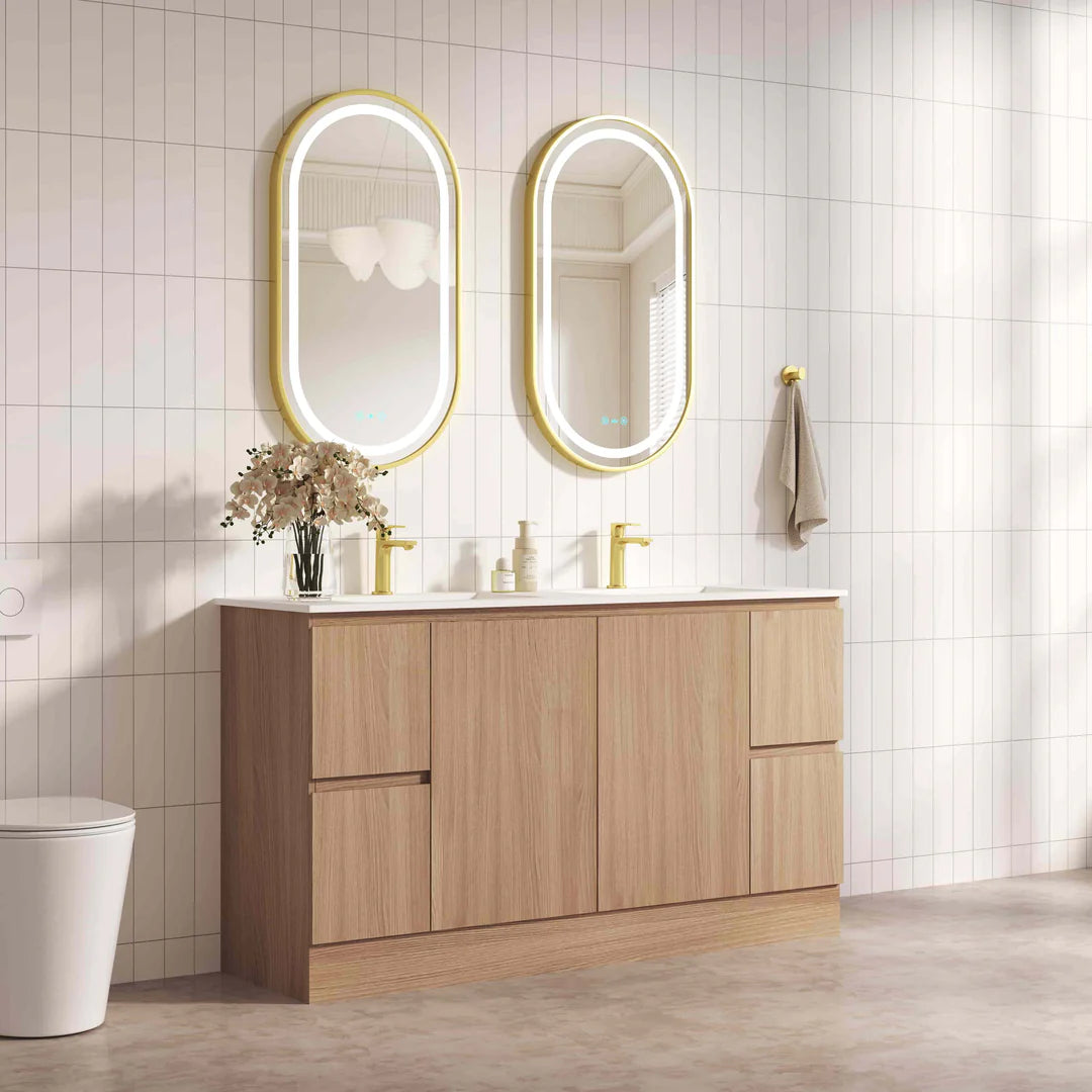 Bathroom vanity with wooden cabinets, white countertop, and illuminated mirrors.