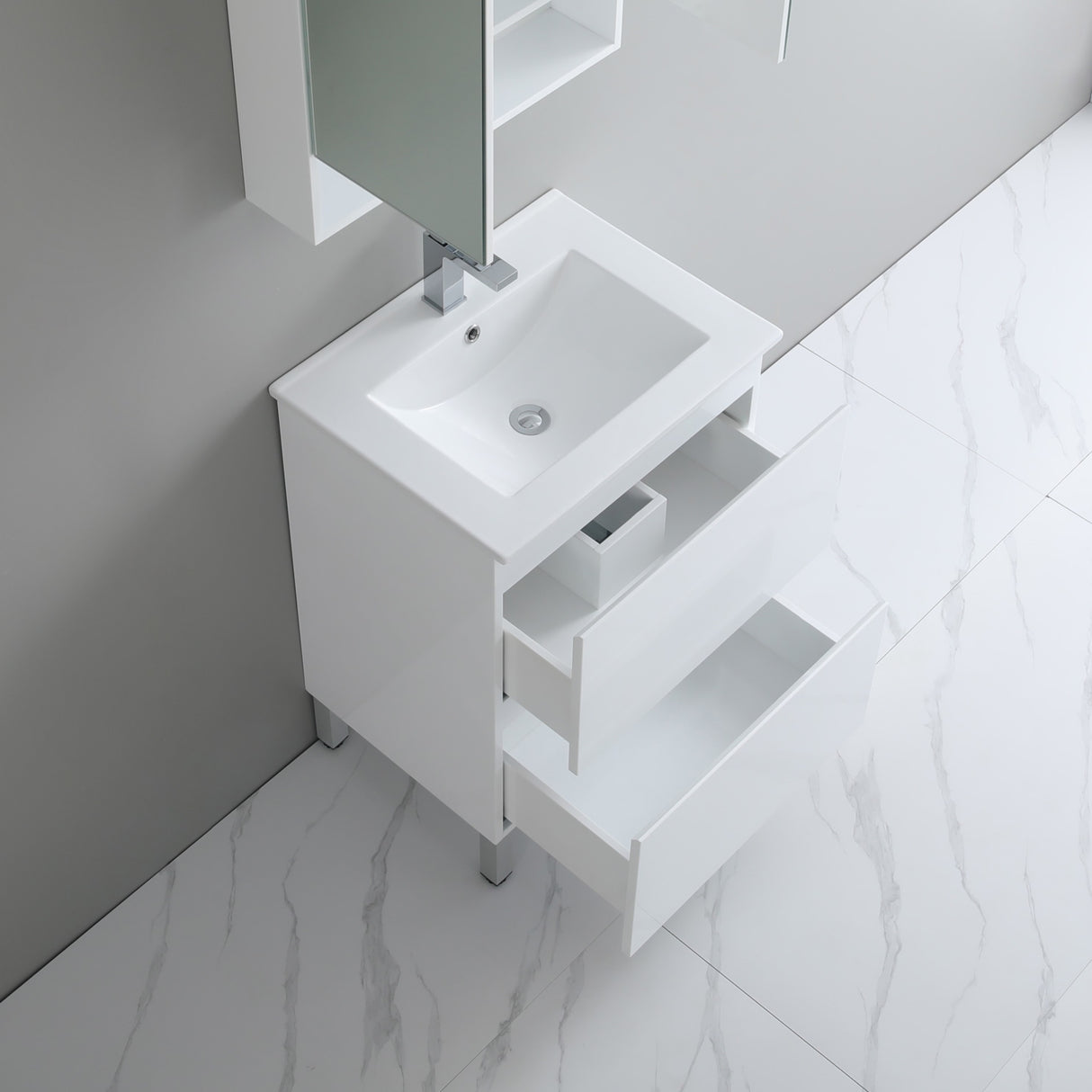 White bathroom vanity with sink in a modern bathroom setting