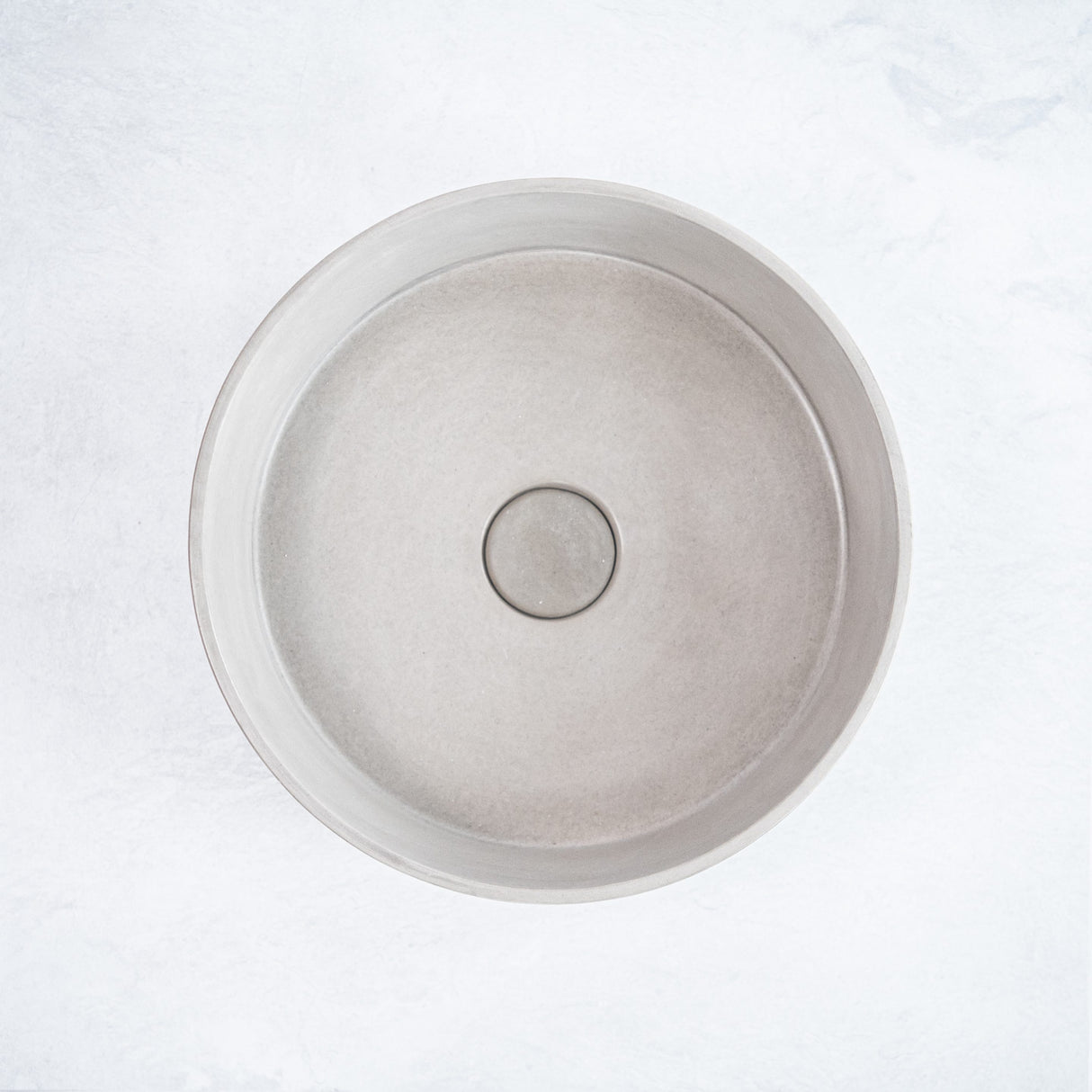 ARLO Round Concrete Basin in Concrete, featuring a smooth circular design with a natural matte finish, ideal for adding a minimalist and modern touch to any bathroom.