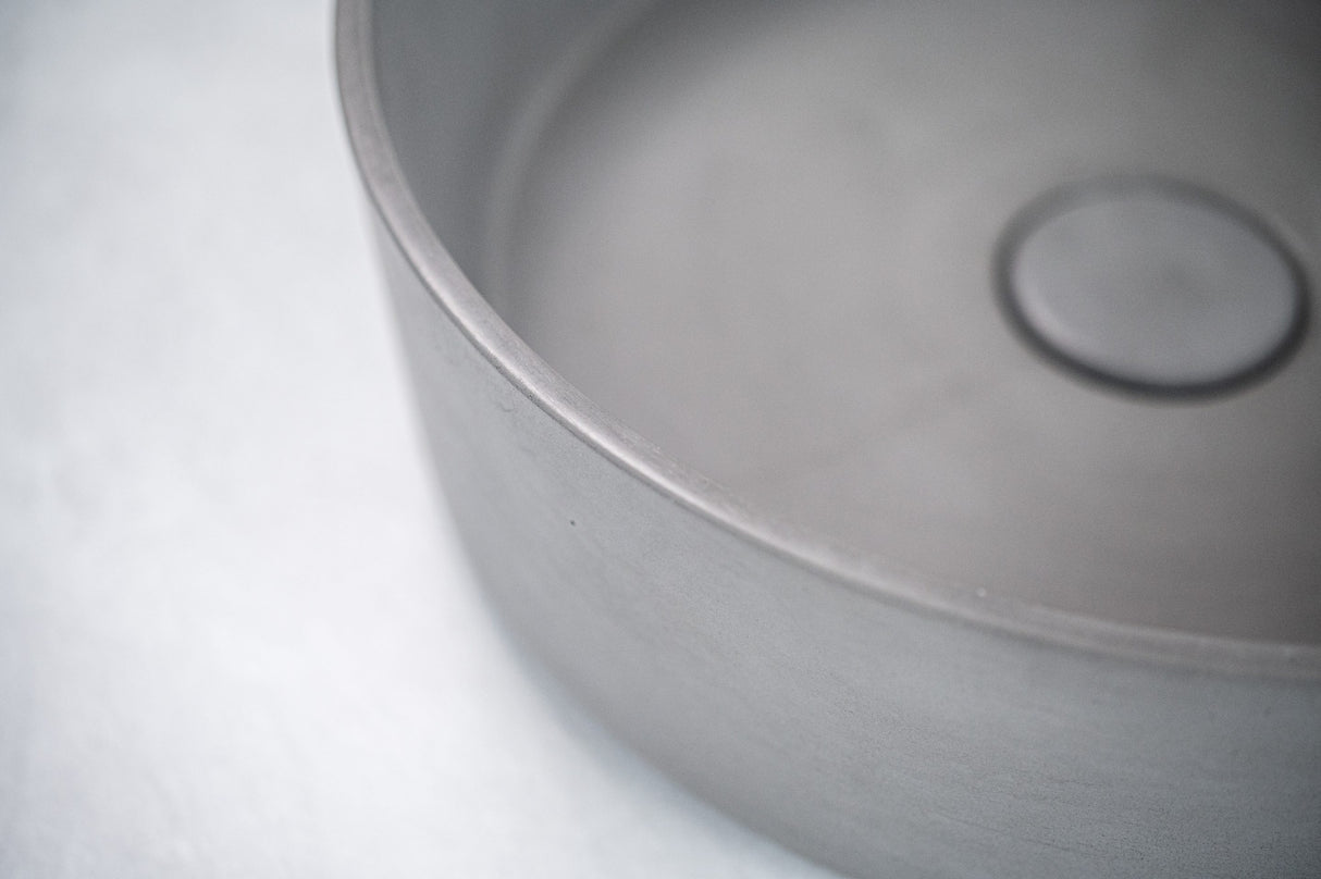 Close-up view of the ARLO Round Concrete Basin in Grey, showcasing its sleek finish and minimalist design.