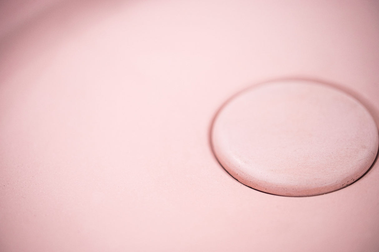 Close-up of the ARLO Round Concrete Basin in Dusty Pink, focusing on the integrated circular drain and smooth matte texture, showcasing its elegant and minimalist design.