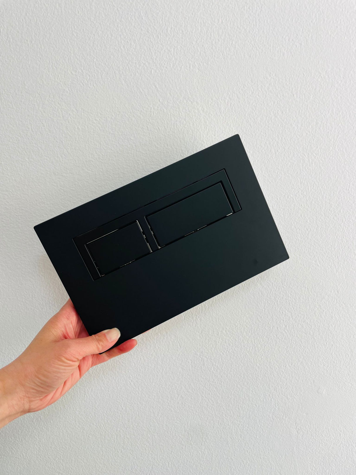 hand holding Black Matte Square flush Button
