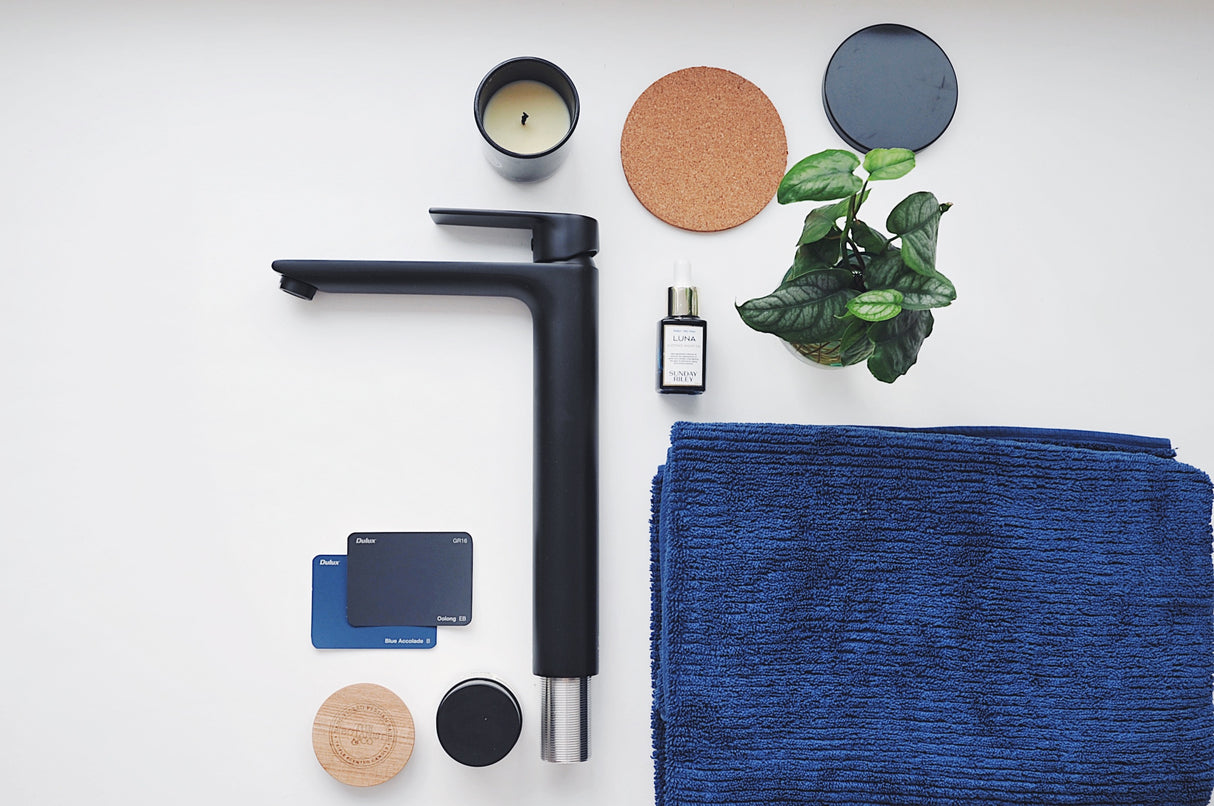 HALE Basin Tall Mixer Black on the table with towel and candle