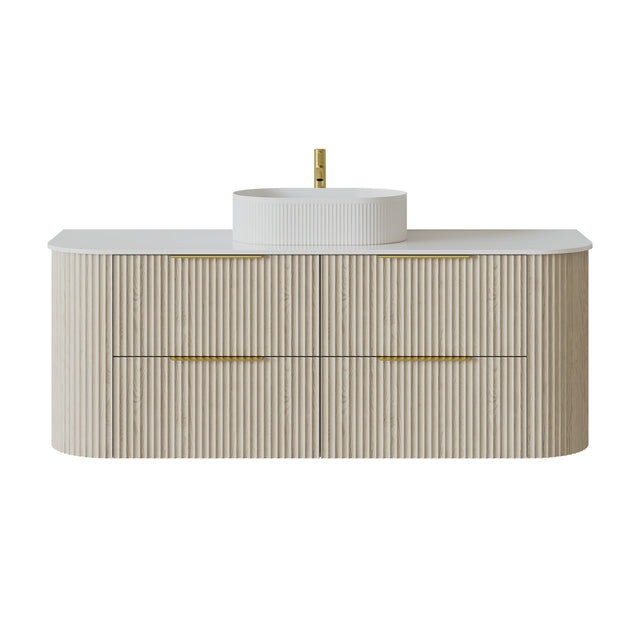 A modern bathroom vanity with a fluted light beige wood cabinet, a white countertop, a white vessel sink, and gold-tone hardware, shown on a plain white background.