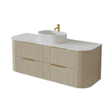 A modern wall-mounted bathroom vanity with a fluted light wood cabinet, a white countertop, a white round vessel sink, and gold-tone hardware, shown on a plain white background.