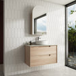 Bathroom with wooden vanity, mirror, and tiled walls
