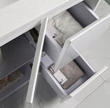 Open drawer with folded clothes inside, likely in a laundry room or storage area.