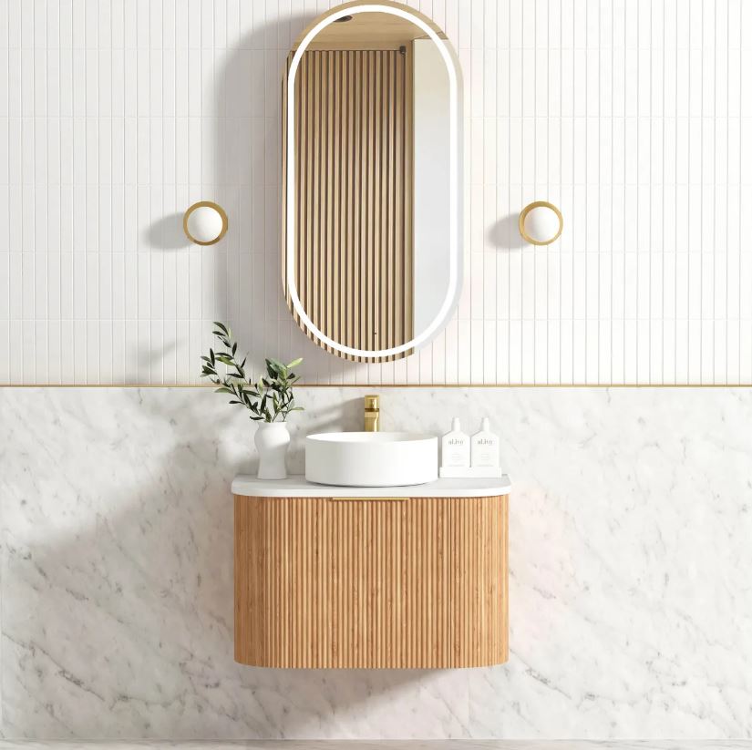 Bathroom with installed mirror and vanity 