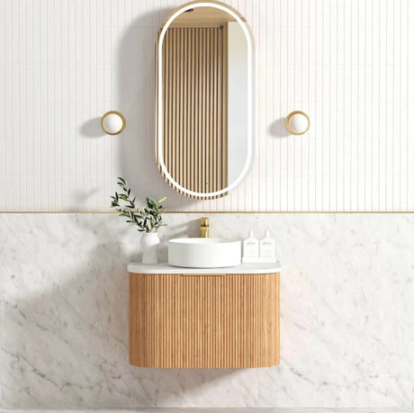 Bathroom with installed mirror and vanity 
