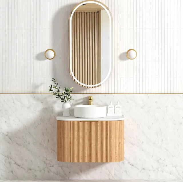 Bathroom with installed mirror and vanity 