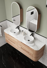 Bathroom vanity with double sink, mirrors, and wooden cabinets.
