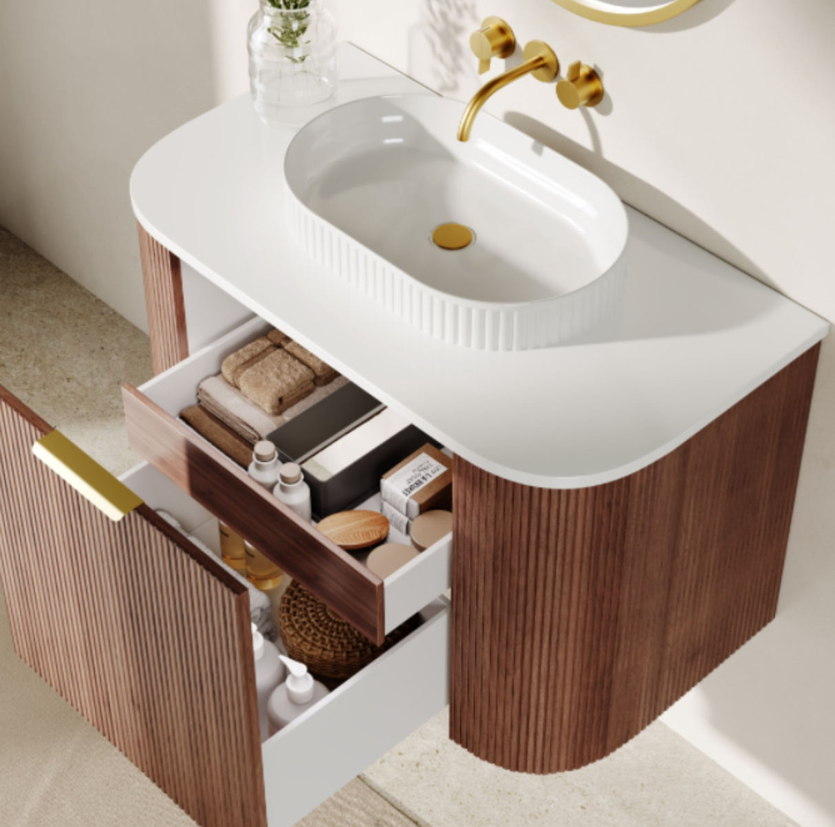 Bathroom vanity with open drawer displaying toiletries, featuring a white sink and gold faucet.