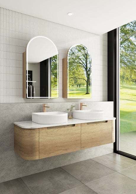 Modern bathroom with wooden vanity, white sinks, and large windows.