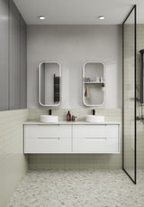 Modern bathroom with white vanity, two sinks, and a glass shower enclosure.