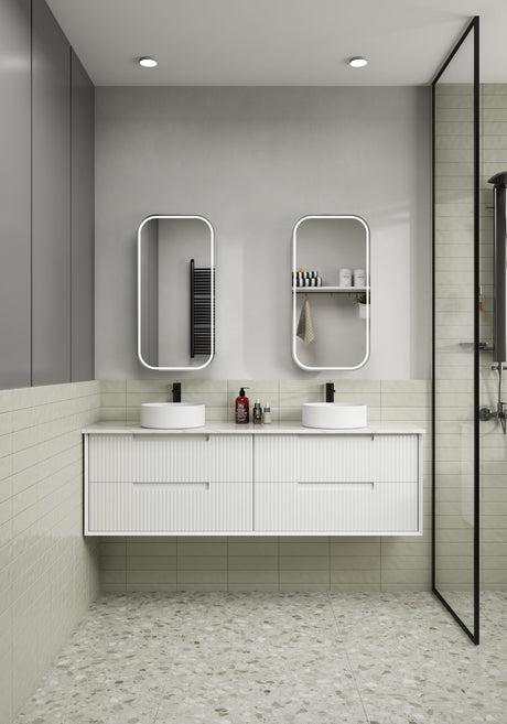 Modern bathroom with white vanity, two sinks, and a glass shower enclosure.
