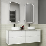 Bathroom vanity with two white sinks, mirrors, and toiletries.
