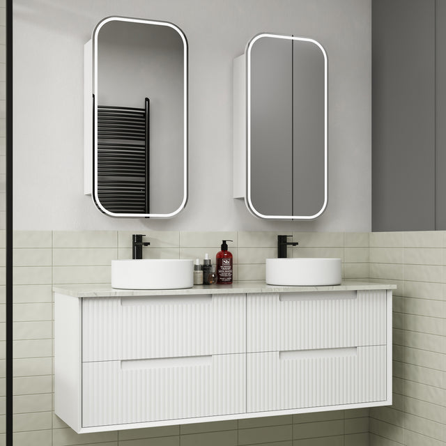 Bathroom vanity with two white sinks, mirrors, and toiletries.