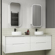 Bathroom vanity with two white sinks, mirrors, and toiletries on a tiled wall.