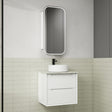 Bathroom vanity with white sink and mirror against a tiled wall.