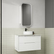 Bathroom vanity with white cabinet, round sink, and rectangular mirror on a tiled wall.