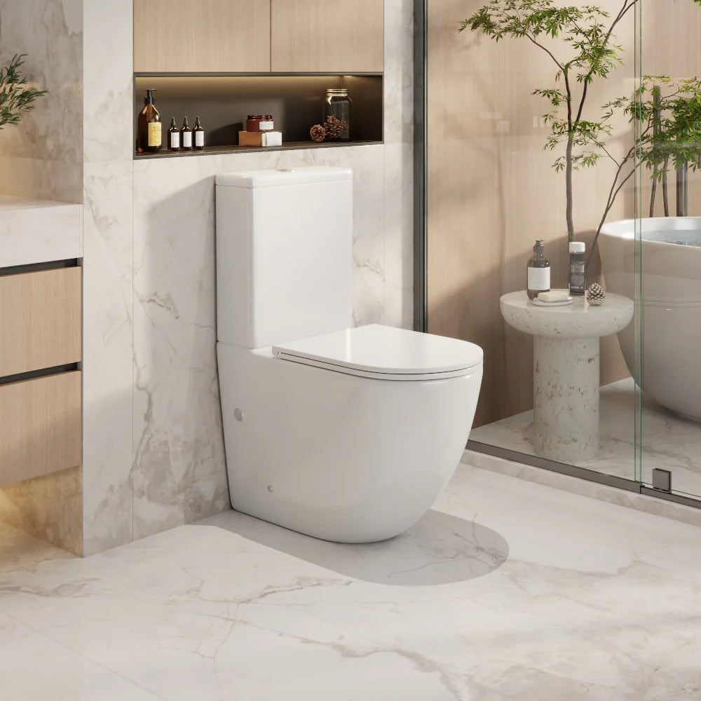 Modern bathroom with a white toilet and marble walls.