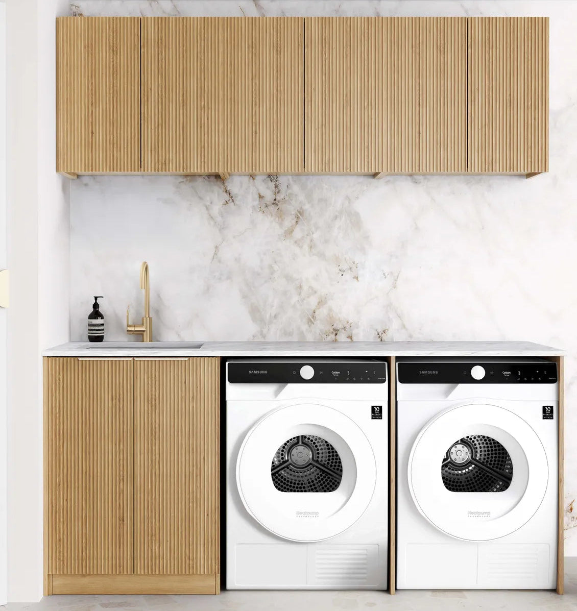 Modern laundry room with wooden cabinets and white marble wall.