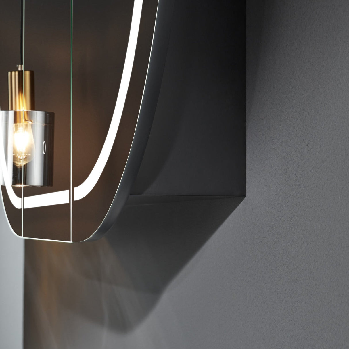 Modern wall-mounted light fixture with a dark finish on a gray background