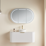 Bathroom setup with a white vanity, sink, and illuminated mirror on a beige wall.