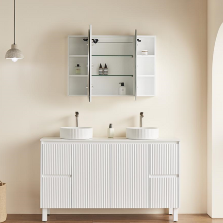 Bathroom vanity with two sinks and a mirror cabinet against a beige wall.